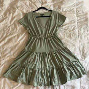 Pastel green tiered babydoll-style dress with short sleeves